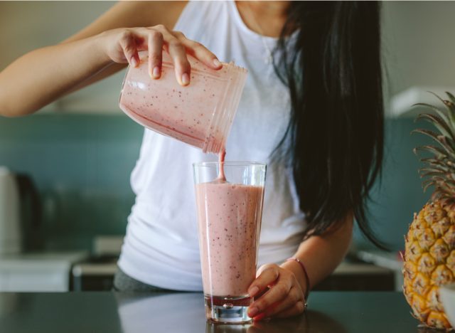 woman making smoothie