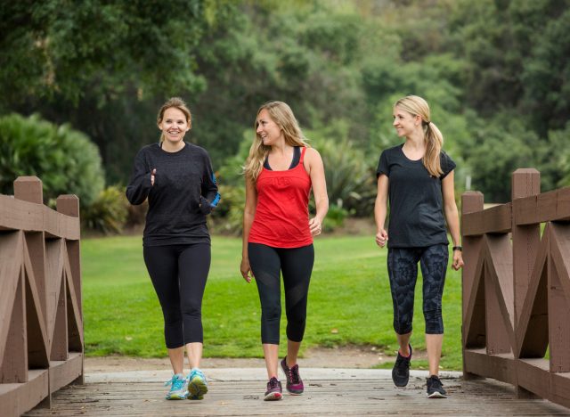 women walking together to burn fat and get active outdoors