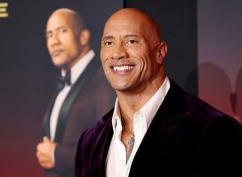 Dwayne "The Rock" Johnson smiling in velvet suit