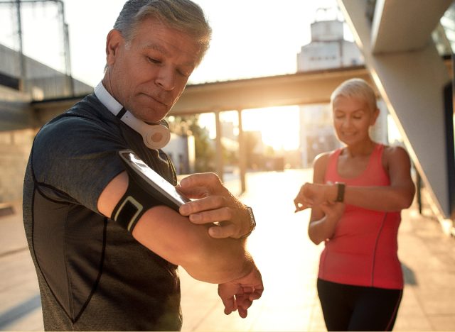 older couple tracking exercise outside