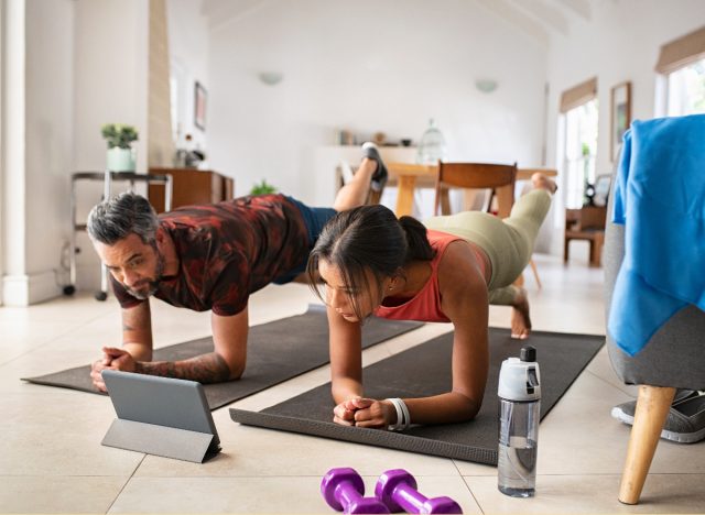 couple exercising on mats indoors