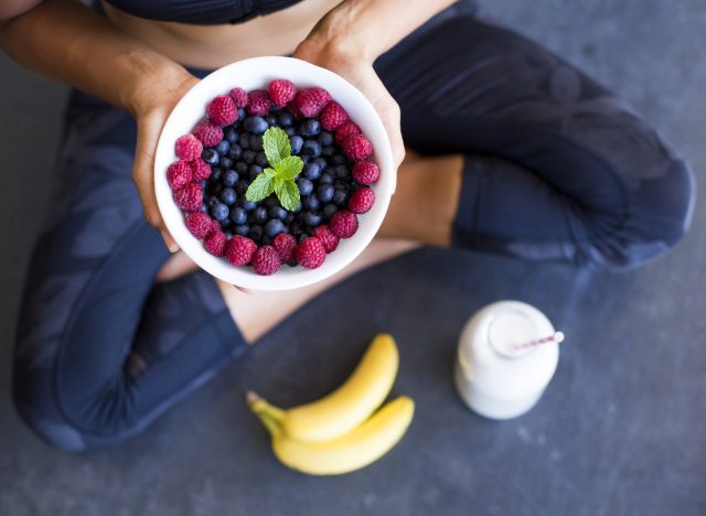 woman holding bowl of berries close-up