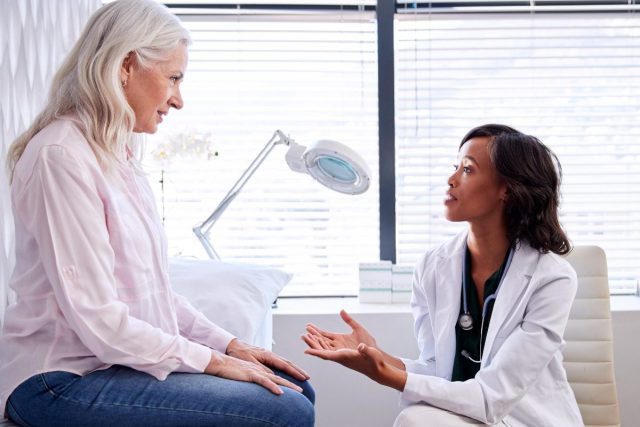 woman having serious chat with her doctor