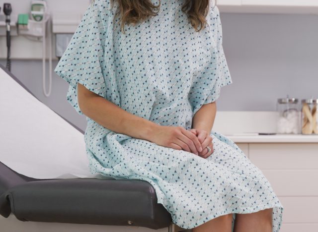 patient in robe sitting on table at doctor's office
