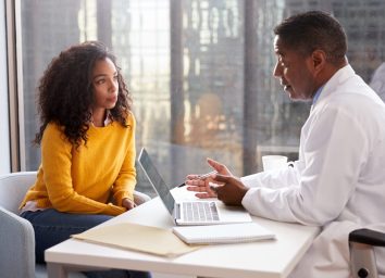doctor and patient having a somber conversation