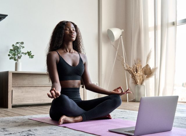 woman peacefully meditates during a virtual session