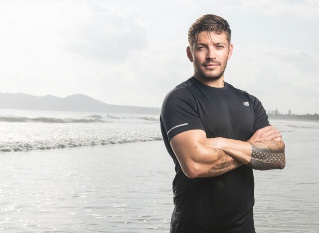 chris hemsworth's personal trainer luke zocchi on beach