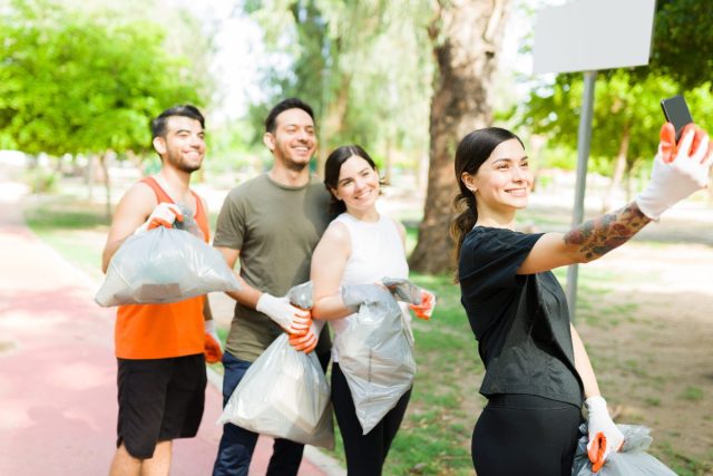 friends pose for selfie while plogging