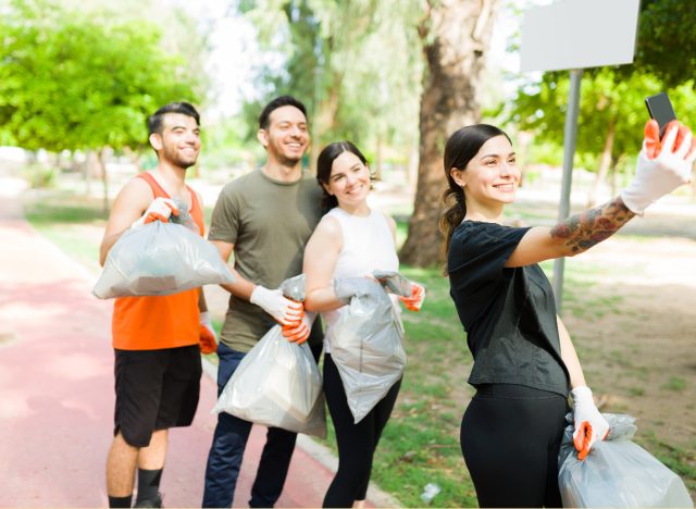 friends pose for selfie while plogging