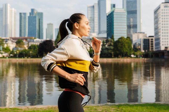 Woman jogging in the city by the water