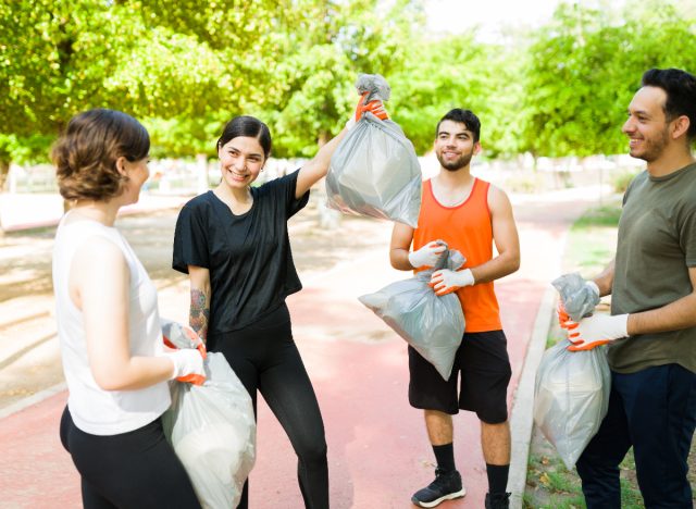 happy group of friends plogging