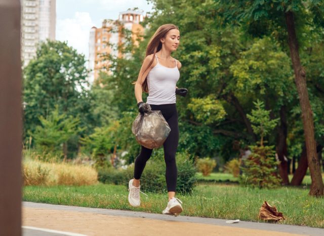 woman jogging to pick up trash, plogging