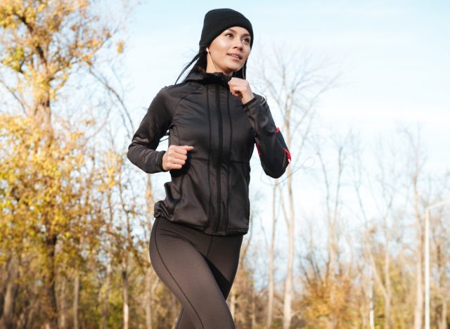 woman running in nature in the cold weather