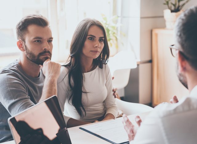 couple listening to doctor in his office