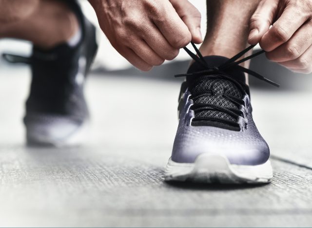 close-up man tying sneakers