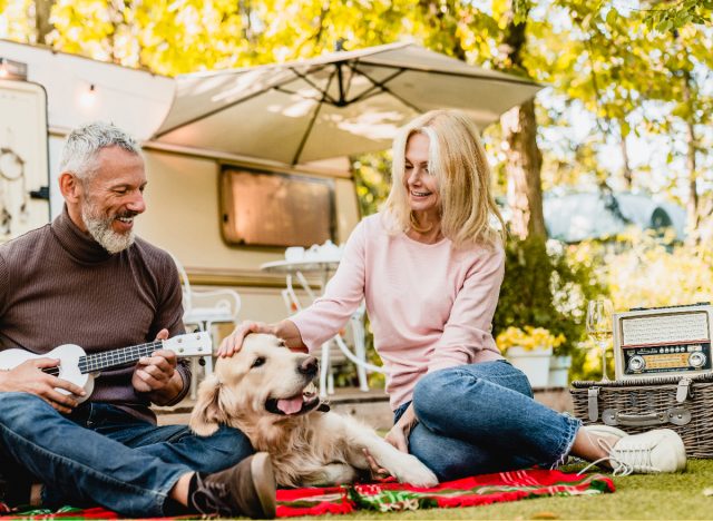 older couple having picnic with their dog