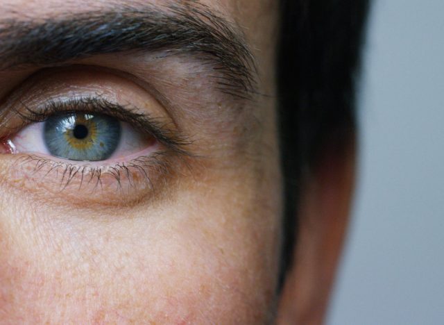 close-up photo of man's blue eye