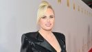 Rebel Wilson posing in sparkly dress at red carpet event