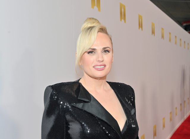 Rebel Wilson posing in sparkly dress at red carpet event