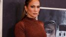 Jennifer Lopez poses in brown sparkly top and skirt at event