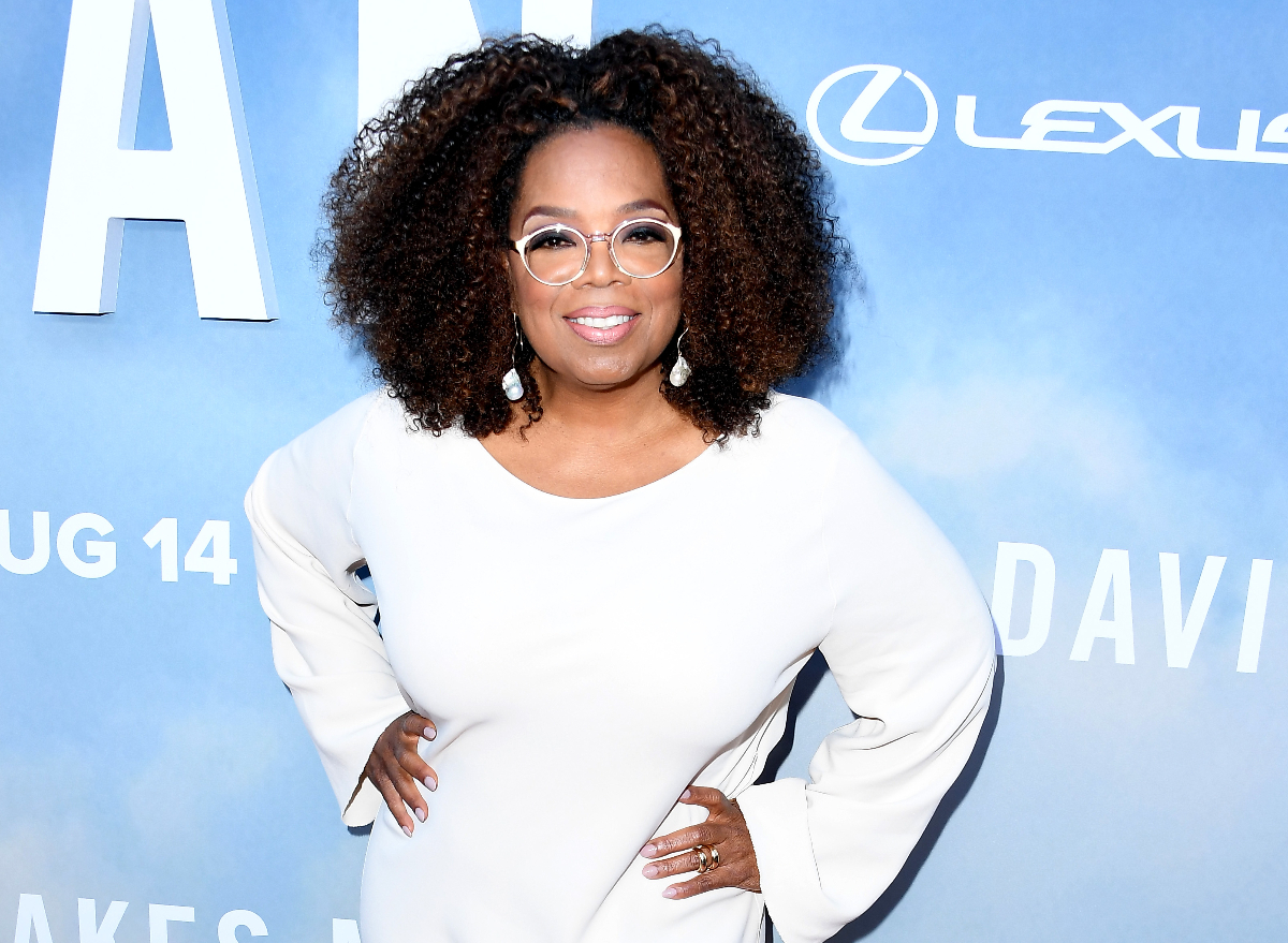 Oprah poses in beautiful white dress at event