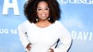 Oprah poses in beautiful white dress at event