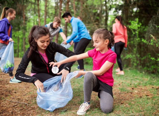 group of joggers collecting trash outside