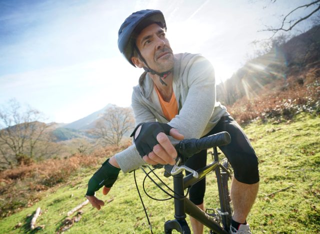 man over 40 on bike in field