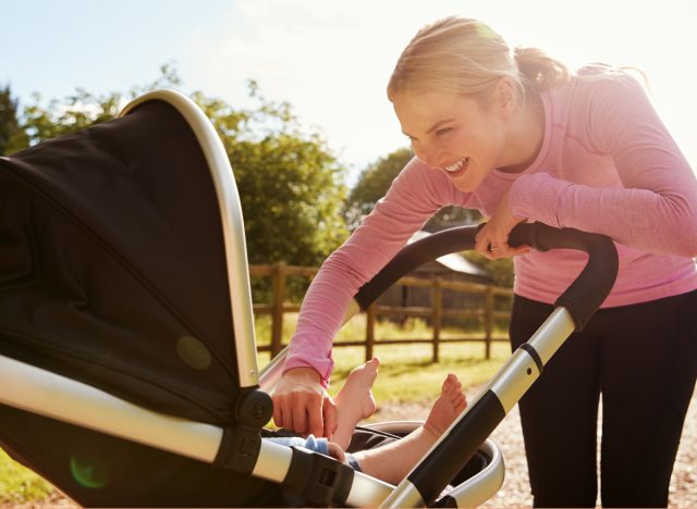 woman in workout attire with new baby in stroller