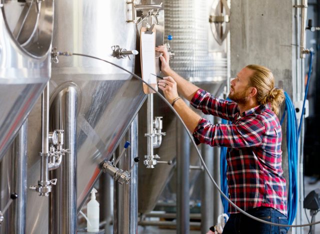 brewery worker checking beer fermentation process