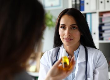 Female GP giving medical marijuana oil to patient.