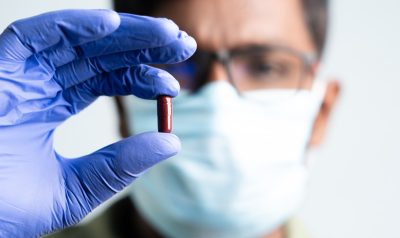 Close up of doctor holding molnupiravir antiviral drug against coronavirus covid 19 outbreak.