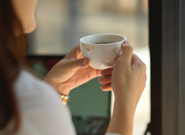 woman drinking coffee by the window