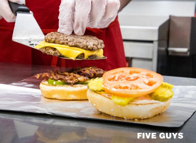 five guys, employees preparing a burger