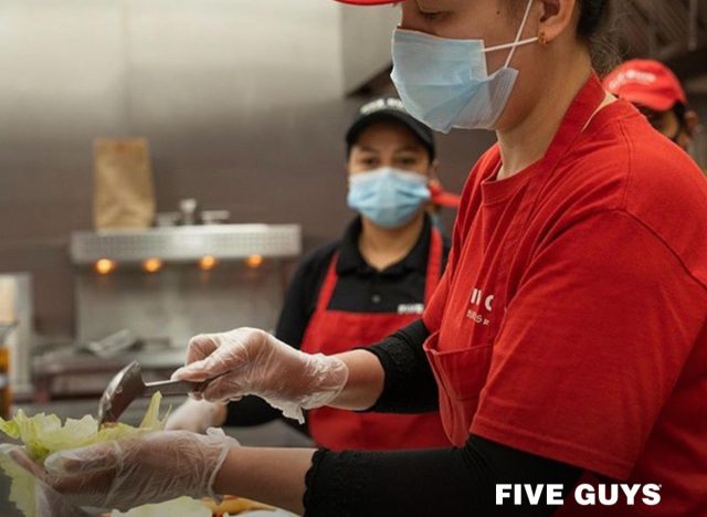 five guys employee preparing food