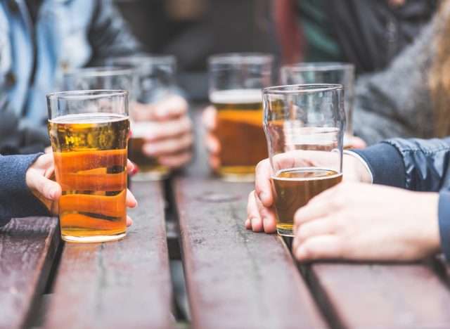 hands holding beer glasses