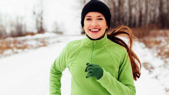happy woman running winter