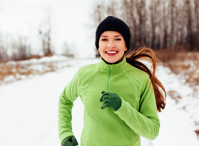 happy woman running winter