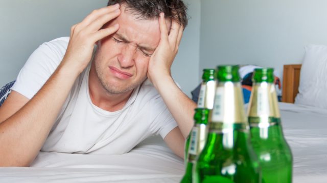 man with headache from hangover
