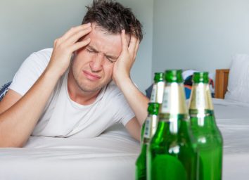 man with headache from hangover