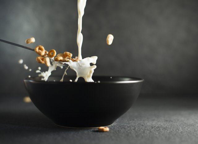 milk pouring into cereal bowl