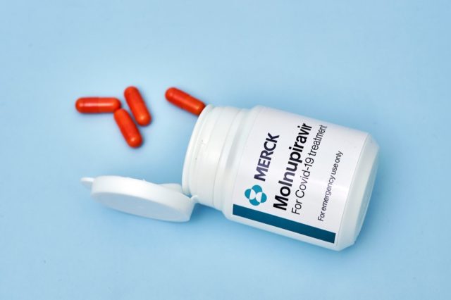Container of Molnupiravir novel coronavirus antiviral treatment.