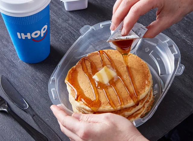 pouring syrup on IHOP pancakes