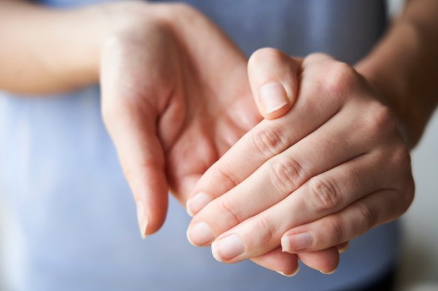 Close Up of a Woman rubbing her hands together with disinfectant