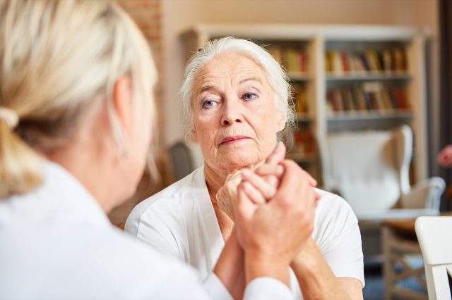 Senior woman in consultation with her female doctor or therapist