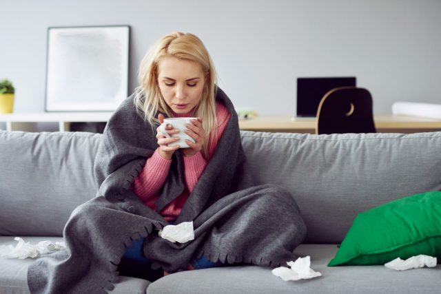 sick woman drinking tea