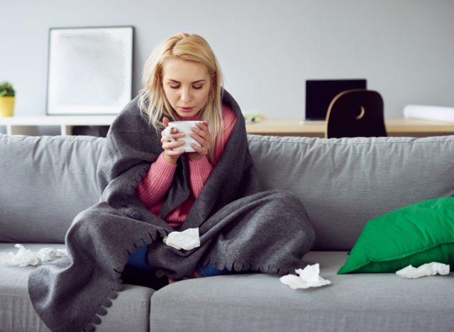 sick woman drinking tea