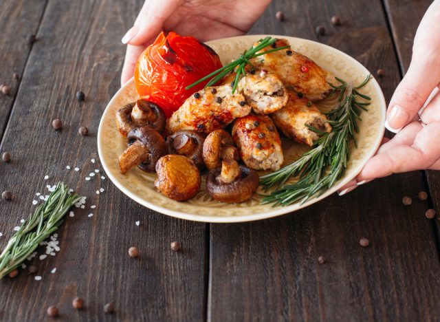 small plate with shish kebab, tomato, and mushrooms