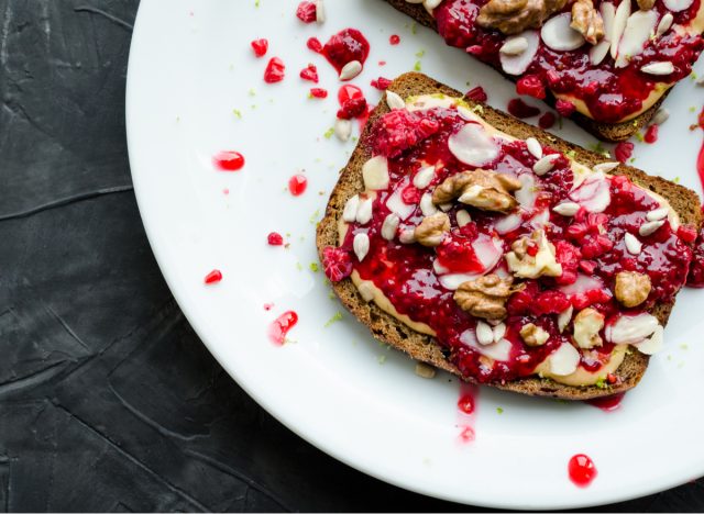 toast with peanut butter, raspberry chia jam and nuts