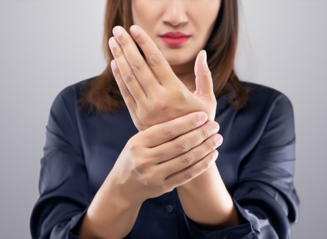 Woman suffering from hand pain.